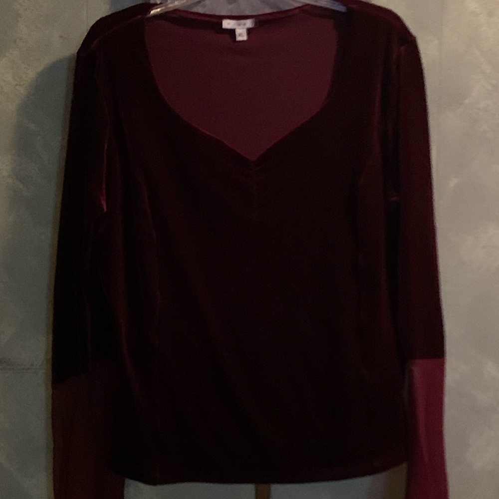 Burgundy velvet top with bell sleeves that flare to a sheer near the cuffs.